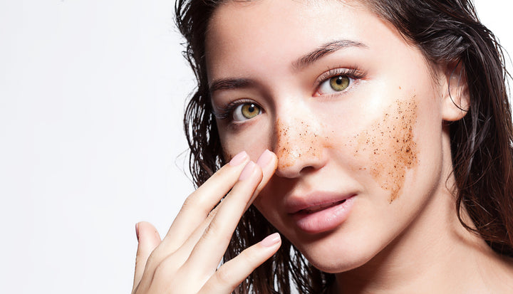 A girl with perfect skin applying exfoliator on face