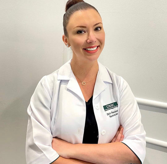 Image of one the skin consultants in Australian Beauty Clinic smiling with a hair bun and orange red lipstick