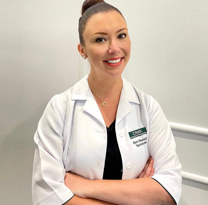 Image of one the skin consultants in Australian Beauty Clinic smiling with a hair bun and orange red lipstick