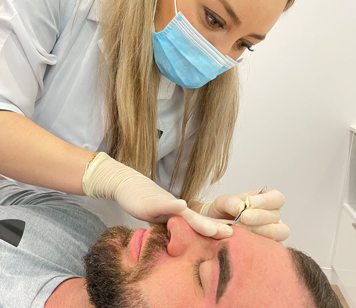 Nikki giving eyebrows waxing treatment to a client 