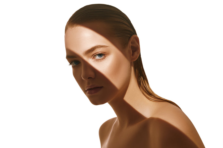 A gorgeous lady with hair gelled back looking at you